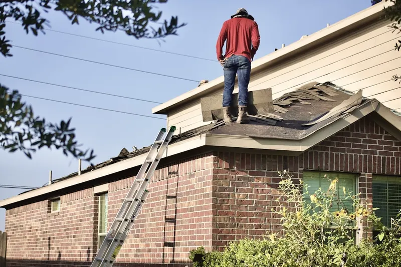 Professional roofer working on a residential roof in New Brighton
